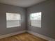 Bedroom features two windows for natural light and classic hardwood floors at 4990 Hooker St, Denver, CO 80221
