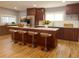 Modern kitchen boasts stainless steel appliances, a center island with seating, and wood floors at 4990 Hooker St, Denver, CO 80221