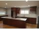A kitchen with hardwood floors, stainless appliances, white subway tile, granite countertops and island at 4990 Hooker St, Denver, CO 80221