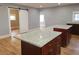 Kitchen with hardwood floors, stainless appliances, island with white granite countertops and brown cabinets at 4990 Hooker St, Denver, CO 80221