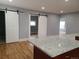 Spacious living room features an island and natural light, with white sliding doors in the background at 4990 Hooker St, Denver, CO 80221