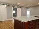 Open-concept living room with granite countertops and rustic barn doors at 4990 Hooker St, Denver, CO 80221
