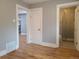 A room with hardwood floors, gray walls, white trim, and a view into the bathroom at 4990 Hooker St, Denver, CO 80221