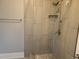 Tiled shower features modern fixtures and a shower head with a handheld sprayer at 4990 Hooker St, Denver, CO 80221