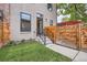 Charming backyard entrance with a new fence and green lawn at 2846 Champa St, Denver, CO 80205