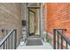 Charming front entrance with black door, brick accents, and decorative lanterns at 2846 Champa St, Denver, CO 80205