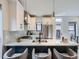 Bright kitchen featuring white cabinets, stainless steel appliances, and stylish pendant lighting at 2846 Champa St, Denver, CO 80205