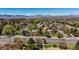 Breathtaking aerial view of the neighborhood with mountain views on a sunny day at 2548 S Zurich Ct, Denver, CO 80219