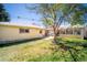 Spacious backyard with lush green lawn, mature trees, and patio perfect for outdoor living at 2548 S Zurich Ct, Denver, CO 80219