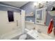 Charming bathroom with a shower-tub combination, storage shelves, updated sink and modern fixtures at 2548 S Zurich Ct, Denver, CO 80219