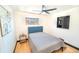 Cozy bedroom boasts hardwood floors, neutral paint, comfortable furniture and updated lighting at 2548 S Zurich Ct, Denver, CO 80219