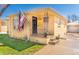 Charming brick home featuring a well-manicured lawn, an American flag, and a quaint front porch with metal railings at 2548 S Zurich Ct, Denver, CO 80219