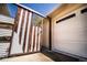 The home features a two-car garage and a unique sliding gate adding security and style to the property's entrance at 2548 S Zurich Ct, Denver, CO 80219