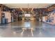 Spacious and organized garage with ample storage, a workbench, and overhead lighting at 2548 S Zurich Ct, Denver, CO 80219