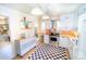 Bright kitchen with white cabinets, stainless steel appliances, black and white flooring, and a pantry at 2548 S Zurich Ct, Denver, CO 80219