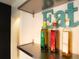 Close-up of kitchen shelving featuring various cooking oils and an Eat decor piece at 2548 S Zurich Ct, Denver, CO 80219