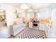 Efficient kitchen with white cabinetry, stainless steel appliances, and checkered flooring at 2548 S Zurich Ct, Denver, CO 80219