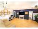 Sunlit living room showcasing hardwood floors, honeycomb shelving, electric fireplace, and modern decor at 2548 S Zurich Ct, Denver, CO 80219