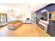 Bright living room featuring hardwood floors, unique lighting fixture, and modern shelving at 2548 S Zurich Ct, Denver, CO 80219