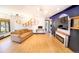 Bright living room featuring hardwood floors, unique shelving and lighting, fireplace, and large window for natural light at 2548 S Zurich Ct, Denver, CO 80219
