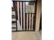 Unique handmade gate with metal and wood planks in red, white, and silver at 2548 S Zurich Ct, Denver, CO 80219