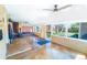 Bright sun room with beautiful windows looking out to the back yard and a wood burning stove at 2548 S Zurich Ct, Denver, CO 80219