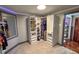 Spacious walk-in closet offering ample storage with built-in shelves, drawers, and clothing racks at 2548 S Zurich Ct, Denver, CO 80219