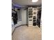 Bright walk-in closet with mirror, custom shelving, drawers, racks, and carpet for maximum storage and organization at 2548 S Zurich Ct, Denver, CO 80219