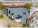 Aerial view shows the roof with solar panels on top of a property that has a large driveway at 4212 E Orchard Pl, Centennial, CO 80121