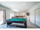 Spacious basement features a comfortable seating area, pool table, and access to outdoor space at 4212 E Orchard Pl, Centennial, CO 80121