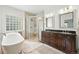 Luxurious bathroom with a soaking tub, glass-enclosed shower, and double vanity, creating a spa-like experience at 4212 E Orchard Pl, Centennial, CO 80121