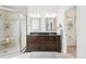 Elegant bathroom featuring dual vanities, a glass-enclosed shower, and modern fixtures at 4212 E Orchard Pl, Centennial, CO 80121