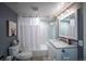 Bright bathroom featuring a shower with white marble, fresh flowers and modern fixtures at 4212 E Orchard Pl, Centennial, CO 80121
