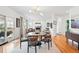 Open-concept dining area boasts hardwood floors, a modern light fixture, and access to the outdoor patio at 4212 E Orchard Pl, Centennial, CO 80121