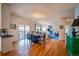 Bright dining area features hardwood floors, light fixture, and flows into the living room at 4212 E Orchard Pl, Centennial, CO 80121