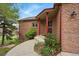 Charming front entrance of a brick home with a well-maintained walkway and mature landscaping, offering curb appeal at 4212 E Orchard Pl, Centennial, CO 80121