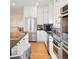 Well-equipped kitchen with stainless steel appliances, granite countertops, and a breakfast bar with counter seating at 4212 E Orchard Pl, Centennial, CO 80121