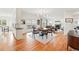 Bright open-concept living room with hardwood floors, dining area, and a fireplace, perfect for entertaining and relaxation at 4212 E Orchard Pl, Centennial, CO 80121