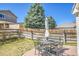 Backyard featuring a patio with outdoor dining furniture, and a privacy fence at 200 Vista Blvd, Brighton, CO 80603