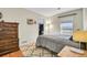 Comfortable bedroom featuring a large rug, dresser, and walk-in closet at 200 Vista Blvd, Brighton, CO 80603