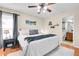 Well-lit bedroom with a king bed, neutral colors, and views into the bathroom at 200 Vista Blvd, Brighton, CO 80603