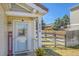 Inviting front porch with a decorative door, house numbers, and a well kept lawn at 200 Vista Blvd, Brighton, CO 80603