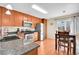 Efficient kitchen with stainless steel appliances, granite countertops, and an adjacent dining area at 200 Vista Blvd, Brighton, CO 80603