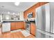 Well-lit kitchen with modern appliances, wooden cabinets, and an open view to the living area at 200 Vista Blvd, Brighton, CO 80603