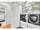 Convenient laundry room with modern washer and dryer units next to a door to the bathroom at 200 Vista Blvd, Brighton, CO 80603