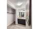 Bathroom featuring vanity with under-cabinet storage and closet with curtain at 65 N Clarkson St # 604, Denver, CO 80218
