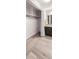 Bathroom with a closet, vanity with dark cabinets, and large mirror at 65 N Clarkson St # 604, Denver, CO 80218