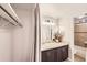 Modern bathroom with vanity and large mirror, next to closet and tiled shower at 65 N Clarkson St # 604, Denver, CO 80218
