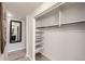 Spacious closet with custom shelving and mirror leading into bathroom at 65 N Clarkson St # 604, Denver, CO 80218