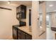 Eat-in kitchen with dark cabinetry, granite countertops, and modern appliances at 65 N Clarkson St # 604, Denver, CO 80218